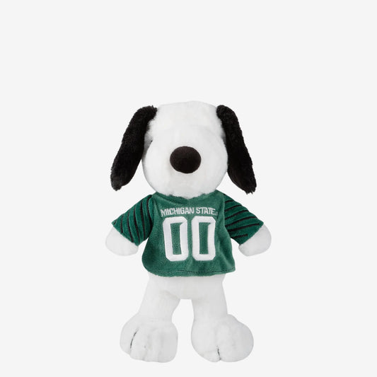 Plush Snoopy stuffed animal wearing a green Michigan State football-style jersey with white embroidered “Michigan State” lettering and the number “00” on the front. The soft white plush character features black floppy ears, a black nose, and embroidered details.