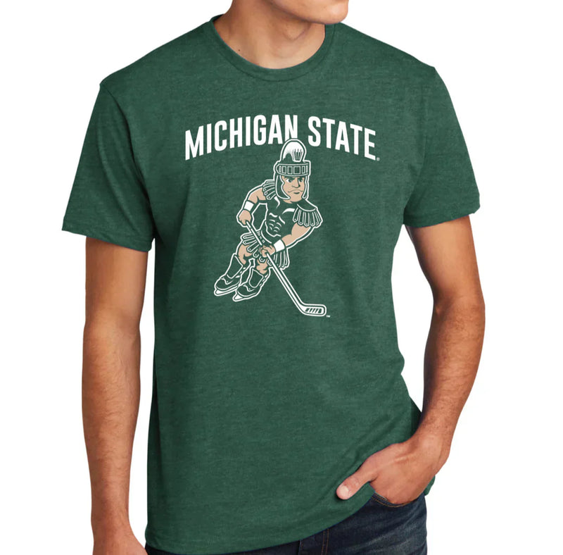 A person wearing a forest green shirt with white text reading "Michigan State" above an image of Sparty wearing skates and holding a hockey stick.