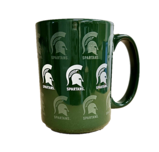 A green ceramic mug with white and frosted screen print graphics of Spartan Helmets all over.