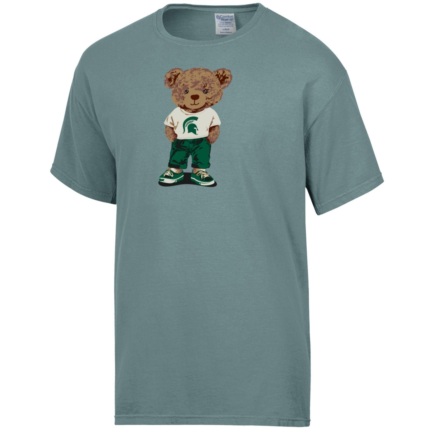 Blue green T-shirt with a brown teddy bear graphic, wearing a white T-shirt with a green Spartan Helmet logo on it, green pants, and green and white shoes. 