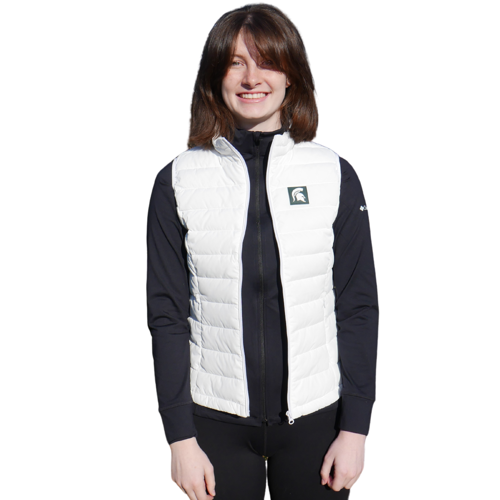 Woman facing forward wearing a white puffer vest that has a small green box with a white Spartan helmet in it at left chest. 