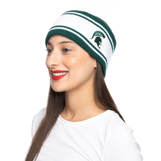 Side angle image of a woman smiling and wearing a white knit winter headband that has green stripes on the top and bottom and a green Spartan Helmet.