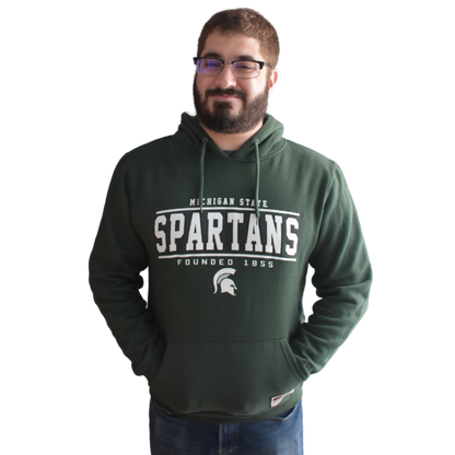 Man modeling the hoodie with his hands in the kangaroo pocket and the hood down.