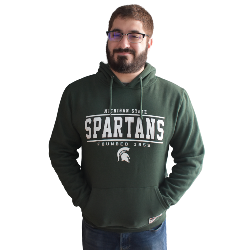 Man modeling the hoodie with his hands in the kangaroo pocket and the hood down
