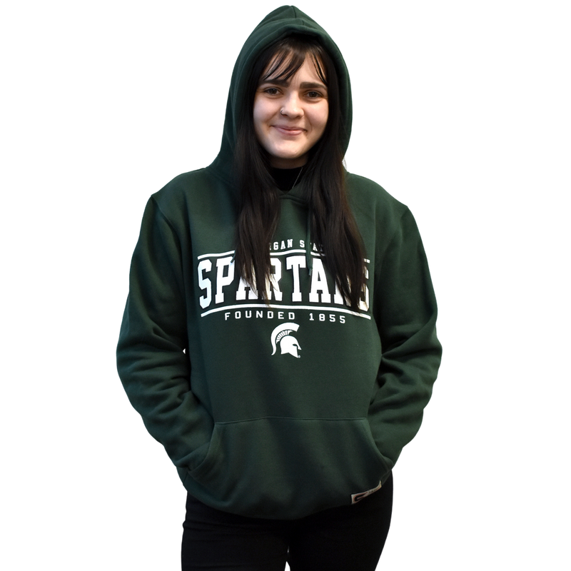 Woman modeling the hoodie with her hands in the kangaroo pocket and the hood up