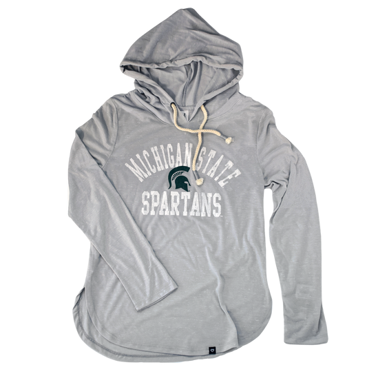 Light heather gray t-shirt hoodie with a rounded hem. The hood's drawstrings are cream-color rope. Printed on the center chest is a green Spartan helmet with arched white text above reading Michigan State in block letters. Below the helmet is white block letters in a straight line reading Spartans.