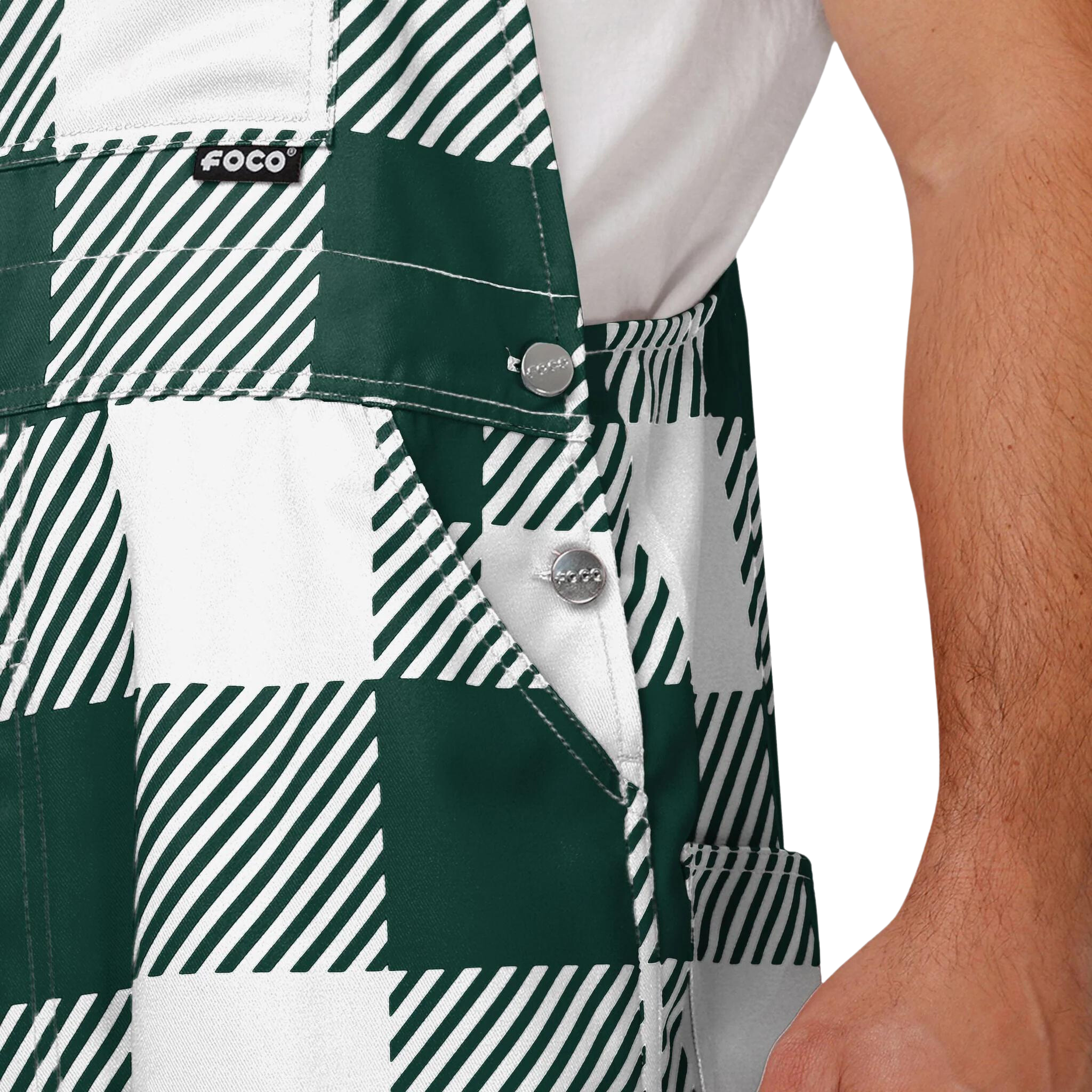 Close up of plaid Michigan State overalls. The colors alternate between green and white. 