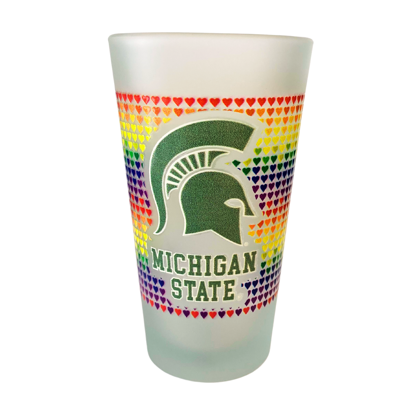 Frosted pint glass with colorful hearts to symbolize Pride, outlining a green glitter Spartan Helmet logo and green glitter text that reads "Michigan State" underneath.