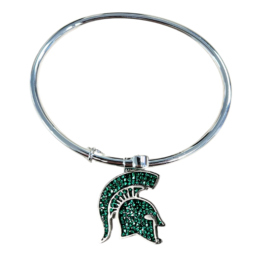 A silver, adjustable bangle style bracelet with a Spartan Helmet logo medallion that is filled with green crystals.
