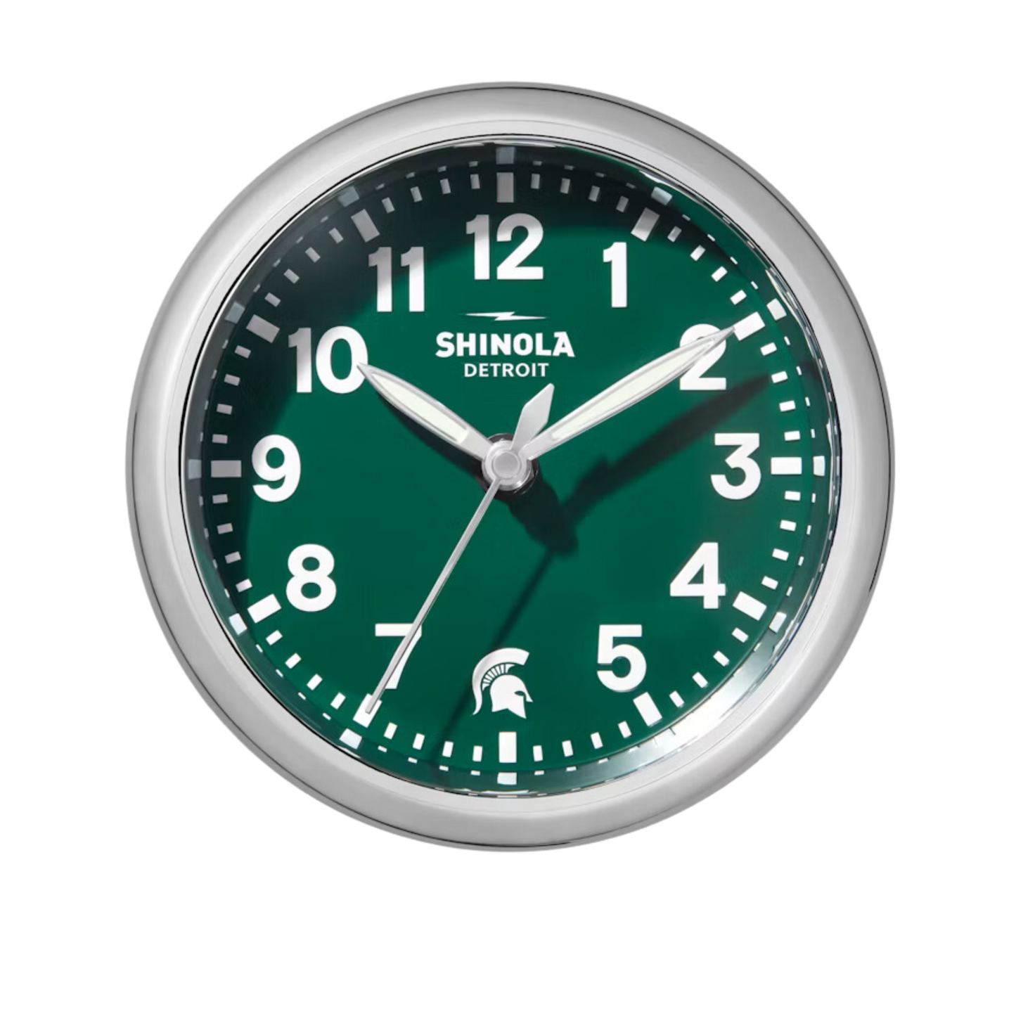 Close up of the Shinola desk clock with a green face, wooden base, and silver rim. The numbers are white and there is a white Spartan Helmet logo in place of the number 6.