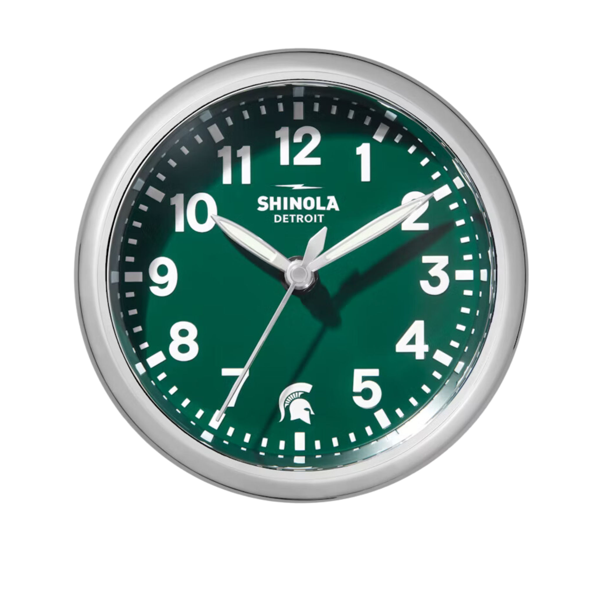 Close up of the Shinola desk clock with a green face, wooden base, and silver rim. The numbers are white and there is a white Spartan helmet logo in place of the number 6.