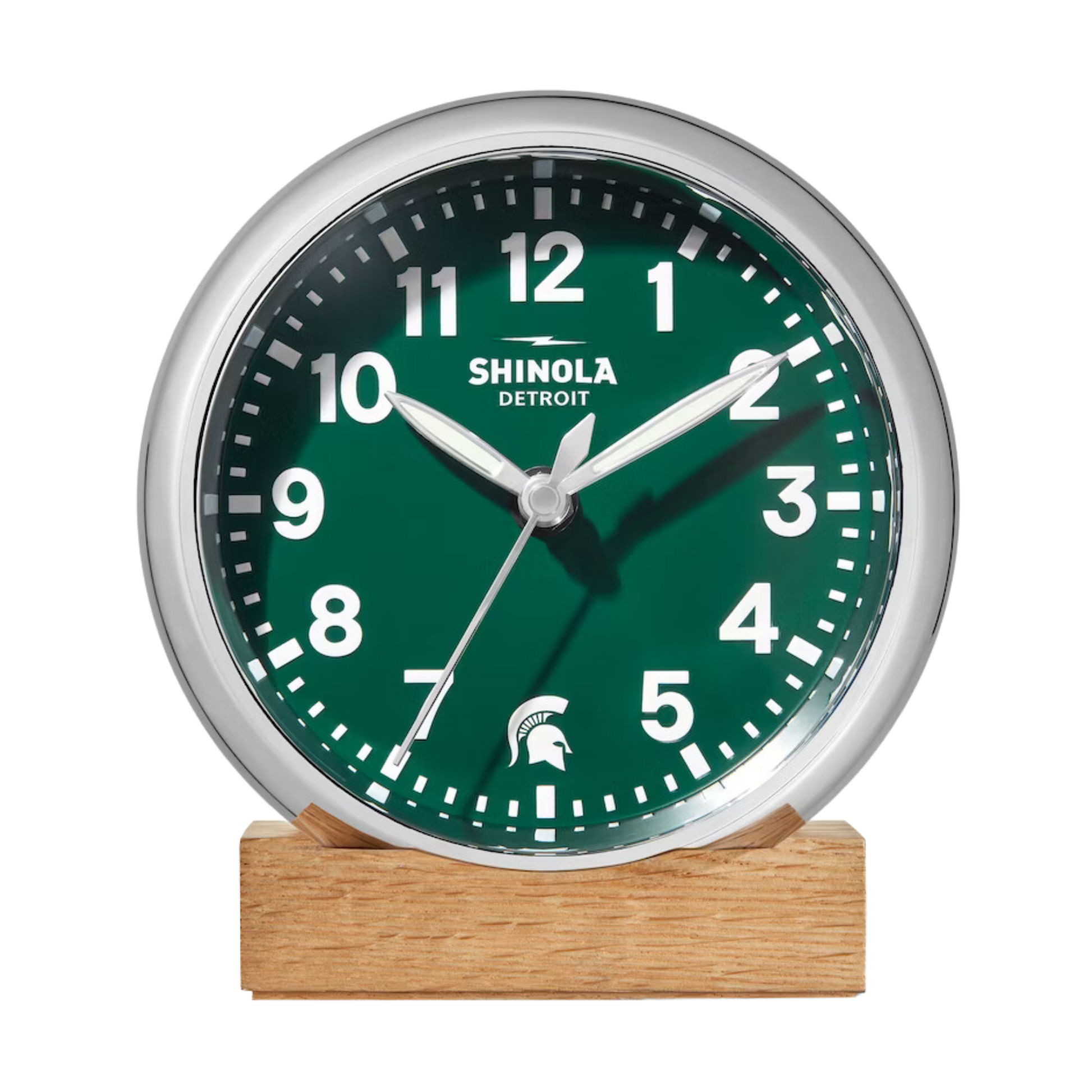 Front of the Shinola desk clock with a green face, wooden base, and silver rim. The numbers are white and there is a white Spartan Helmet logo in place of the number 6.