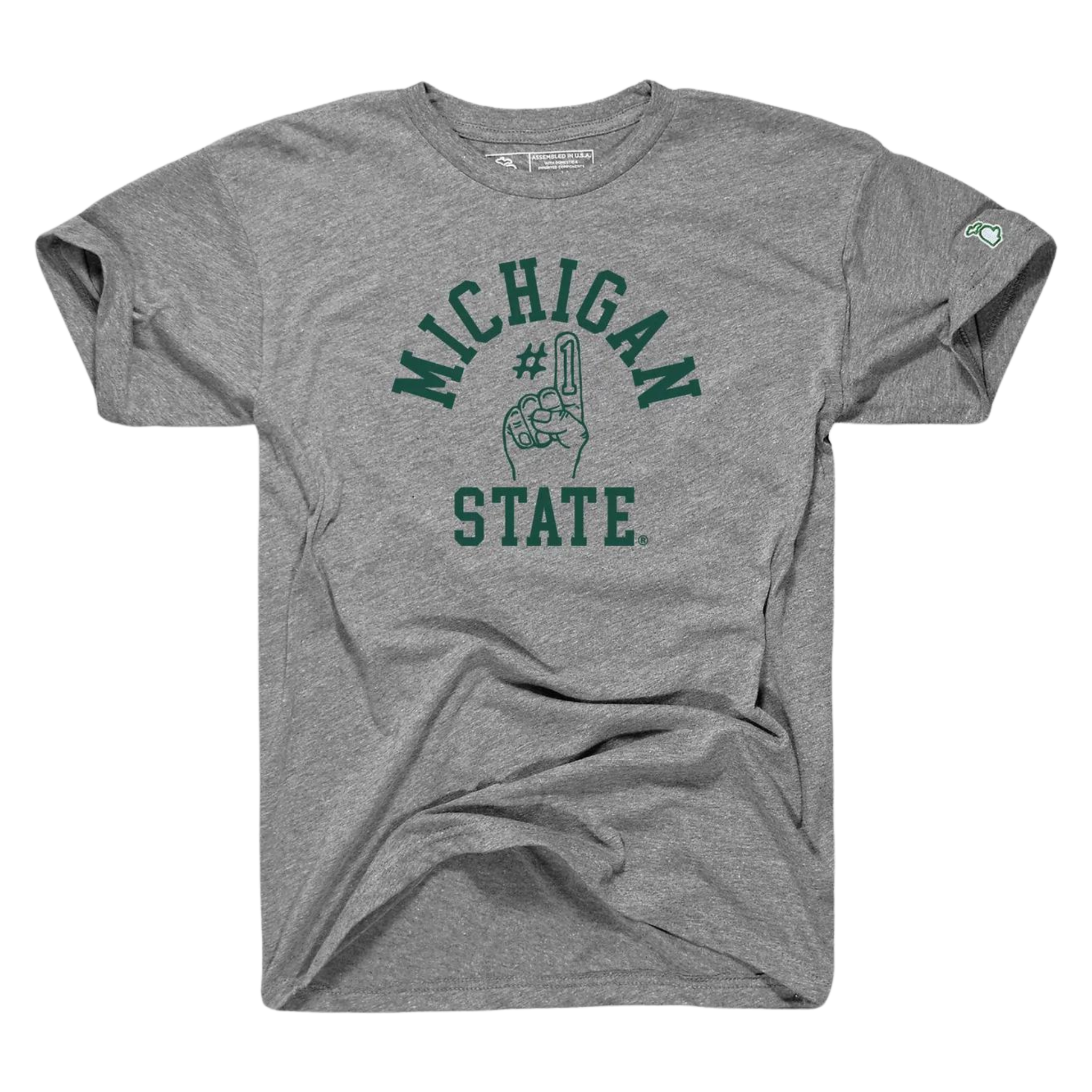 A gray tee shirt with the words Michigan State written in green on the center torso. In the middle of the two words, a graphic of a foam finger with #1 on the index finger is outlined in green.
