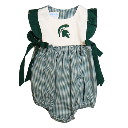 Front of a sleeveless baby jumper. The green and white plaid bottom has a bubble effect in shape. The top is white with dark green ruffle trim ending in bows at the hip. A dark green Spartan Helmet is embroidered on the center chest.