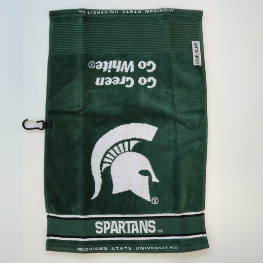 A dark green golf towel with a large white Spartan Helmet logo in the center. Underneath the logo is the word "Spartans" written in all caps in white, followed by a smaller print "Michigan State University." Above the helmet logo, facing the opposite direction, are the words Go Green Go White in italics. 