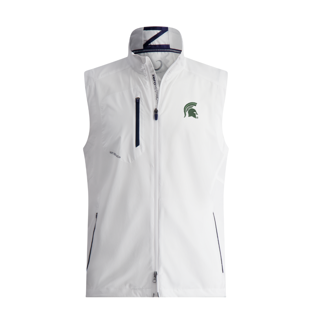 White vest with a water resistant valuables pocket, dual-direction zipper technology, an interior wind flap, a modified power Torque back, and an anti-chafe chin guard. The pocket zippers are black and the two way main zipper is white. On the upper left chest is a green embroidered Spartan Helmet logo. Shown on a white background. 