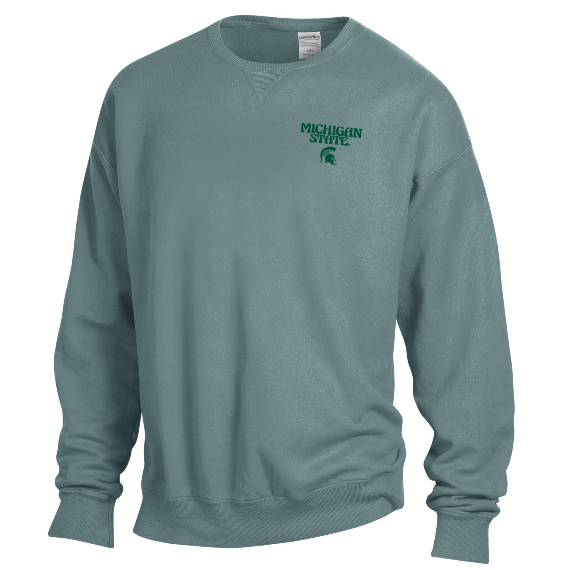 The front of a blue crewneck that reads "Michigan State" in a groovy font above a green Spartan helmet logo on the upper left chest.