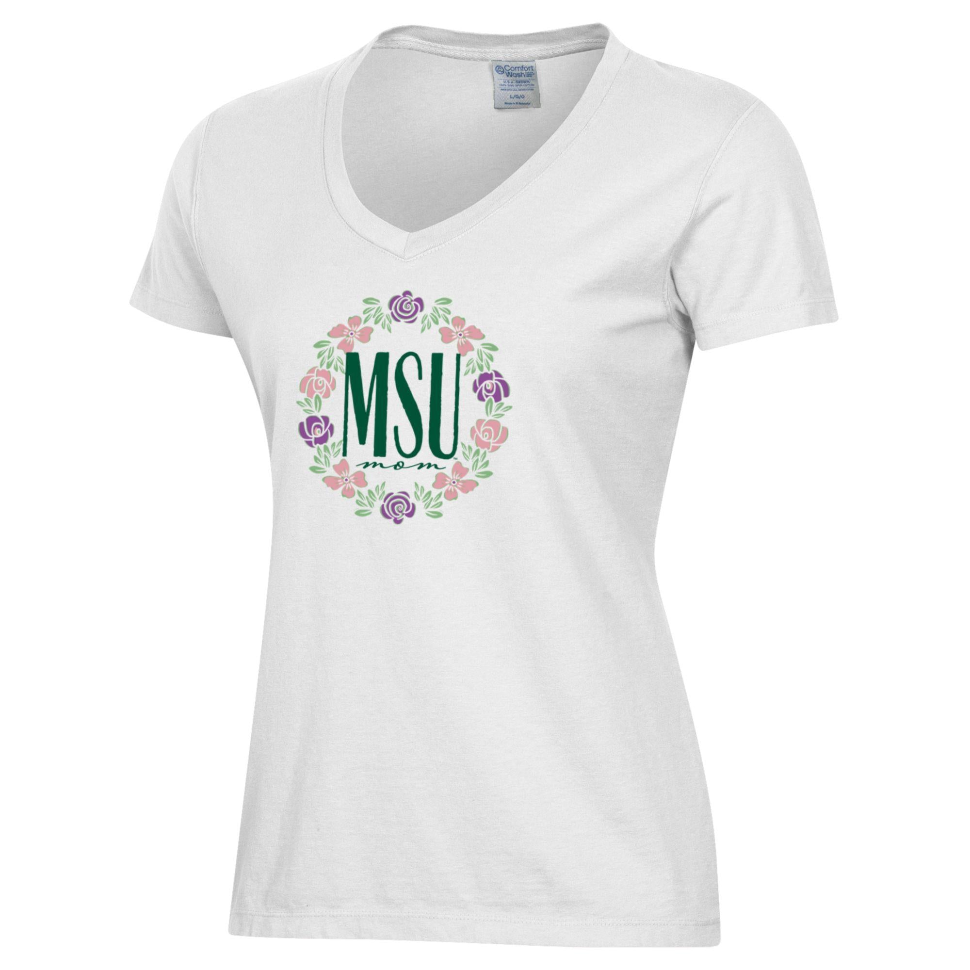 A white v-neck t-shirt with a pink and purple floral wreath encircling the words "MSU Mom" in green.