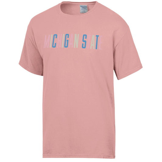 A coral pastel-colored short sleeve T-shirt with "Michigan State" written across the front in multicolor block letters.