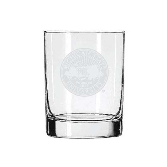 Clear Michigan State University rocks glass featuring a frosted etched university seal with the text “Michigan State University” and “Founded 1855” centered on the front. The heavy-bottom glass has straight sides and a thick base.