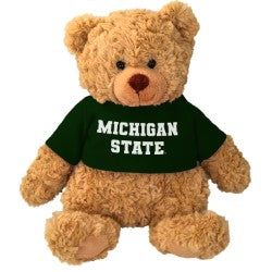 Light brown plush bear wearing a green 
'Michigan State' shirt. 