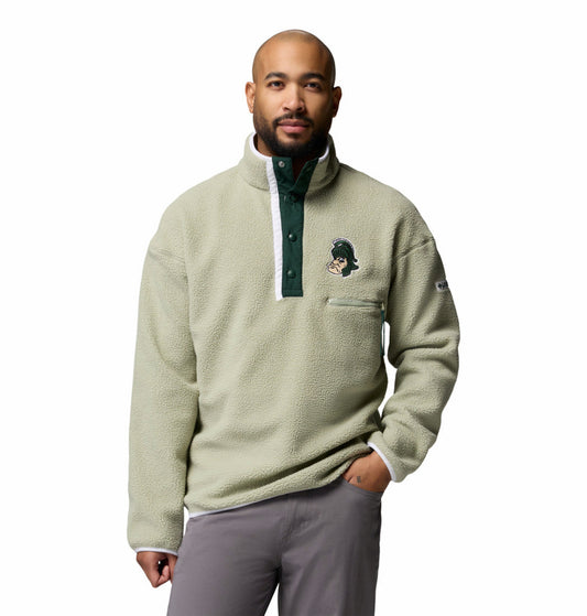 Model wearing a light sage green sherpa fleece pullover featuring a high stand collar and snap-button placket with dark green trim. The left chest displays a vintage-style Spartan mascot logo patch above a zippered chest pocket. The long-sleeve pullover has a soft textured fleece fabric and relaxed fit.