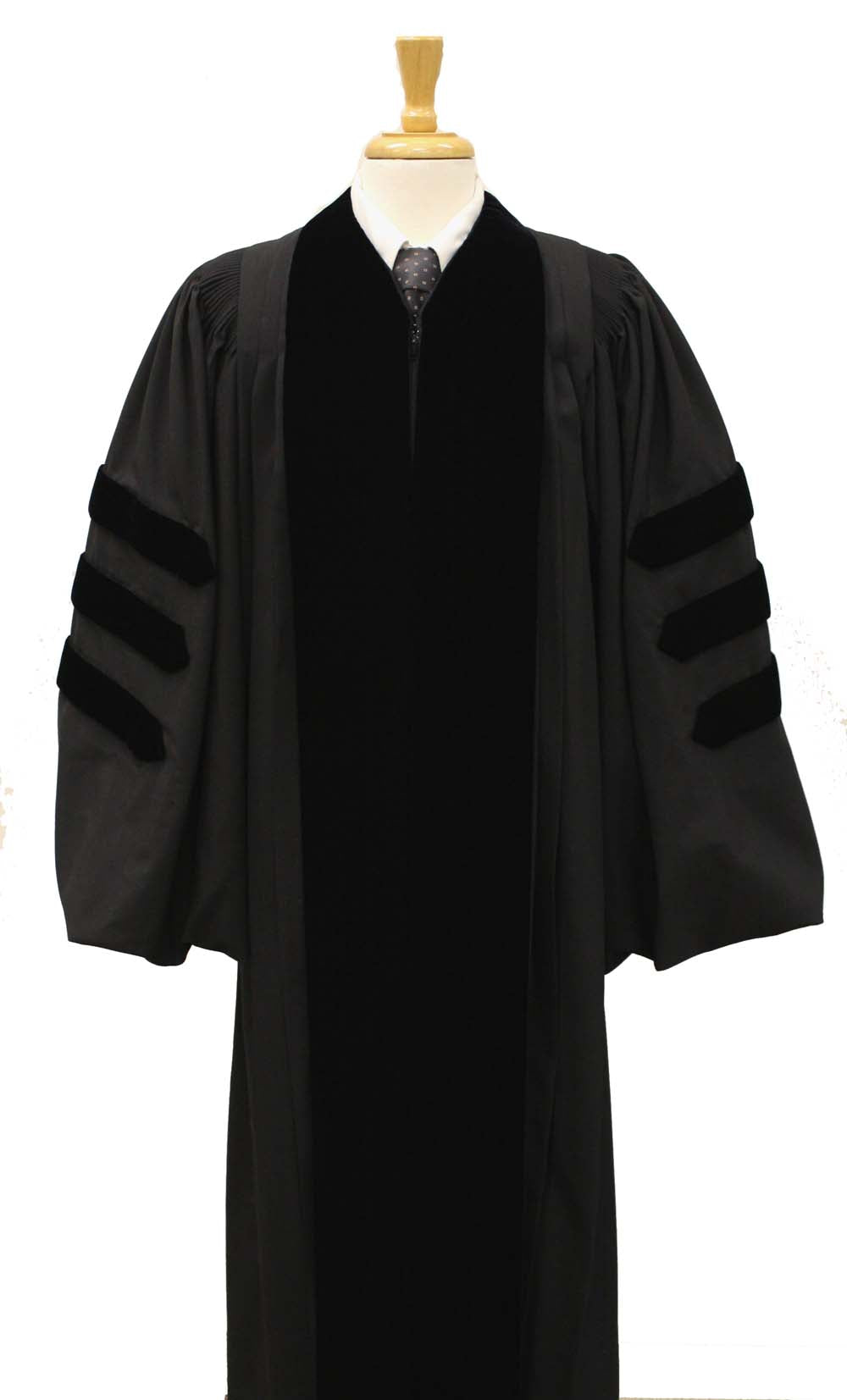 Black doctoral academic gown with velvet panels and three velvet bars on each sleeve, displayed on a mannequin torso with a wooden stand.