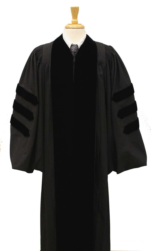 Black doctoral academic gown with velvet panels and three velvet bars on each sleeve, displayed on a mannequin torso with a wooden stand.