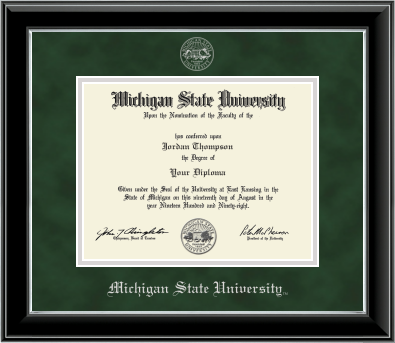 Framed Michigan State University diploma in a black glossy frame with a silver inner edge. The matte is dark green, featuring the university seal at the top center and 'Michigan State University' written in silver at the bottom center.