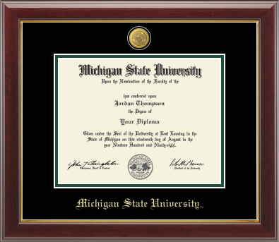 Framed Michigan State University diploma in a dark wood frame with a gold inner edge. The matte is black with a green inner border surrounding the diploma. Michigan State seal is at the top of matte and is gold engraved. "Michigan State University" is inscribed in gold at the bottom of the frame.