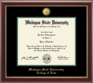 The diploma is displayed in a dark wood frame with a black matte and gold trim, and includes signatures from university officials. In gold and cursive writing is "Michigan State University." Below in gold cursive letters is "College of Law." 