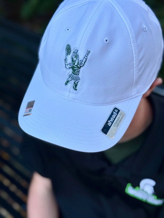 Person modeling a white cap with a green embroidered Sparty playing tennis. The Ahead brand logo is made visible in the image.